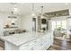 Open-concept kitchen island with pendant lighting, white cabinets, and granite countertops at 1614 Garden Park Cir, Fuquay Varina, NC 27526