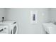 Clean laundry room featuring modern washer, dryer, and utility sink at 1614 Garden Park Cir, Fuquay Varina, NC 27526