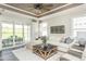 Inviting living room with a large sectional sofa, a rustic coffee table, and natural light at 1614 Garden Park Cir, Fuquay Varina, NC 27526