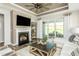 Comfortable living room featuring a fireplace, and sliding glass doors leading to an outdoor patio at 1614 Garden Park Cir, Fuquay Varina, NC 27526