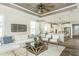 Spacious living area with a white sofa, an open layout with sight lines to the kitchen at 1614 Garden Park Cir, Fuquay Varina, NC 27526