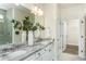 Bathroom with double sink vanity featuring granite countertop and views into the glass enclosed shower at 1622 Garden Park Cir, Fuquay Varina, NC 27526