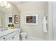 Relaxing bathroom showcasing a bright mirror, a white vanity, and modern fixtures at 1622 Garden Park Cir, Fuquay Varina, NC 27526