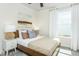 Cozy bedroom features a wood frame bed, neutral decor, and soft natural lighting at 1622 Garden Park Cir, Fuquay Varina, NC 27526
