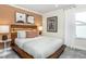 Comfortable bedroom showcasing modern wall art, a wooden frame bed, and lots of natural light at 1622 Garden Park Cir, Fuquay Varina, NC 27526