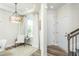 Bright foyer with a decorative light fixture and comfortable seating by the window at 1622 Garden Park Cir, Fuquay Varina, NC 27526