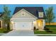 Charming single-Gathering home with a two-car garage, inviting curb appeal, and well-maintained landscaping at 1622 Garden Park Cir, Fuquay Varina, NC 27526