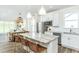 Bright kitchen with an island, stainless steel appliances, white cabinets, and plenty of natural light at 1622 Garden Park Cir, Fuquay Varina, NC 27526