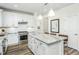 Well-equipped kitchen featuring granite countertops, subway tile backsplash, a center island, and stainless appliances at 1622 Garden Park Cir, Fuquay Varina, NC 27526