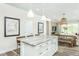 Open-concept kitchen with an island, barstool seating, and a view of the dining and living areas at 1622 Garden Park Cir, Fuquay Varina, NC 27526