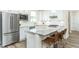 Modern kitchen with stainless appliances, granite countertops, white subway tile, and seating at the island at 1622 Garden Park Cir, Fuquay Varina, NC 27526