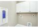 Efficient laundry room with white cabinets and utility connections at 1622 Garden Park Cir, Fuquay Varina, NC 27526