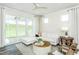 Bright living room with a sectional sofa, accent chairs, modern decor, and access to the outdoor space at 1622 Garden Park Cir, Fuquay Varina, NC 27526