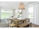 Inviting dining room with a wooden table and a view into the light and airy living room at 1622 Garden Park Cir, Fuquay Varina, NC 27526
