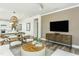 Open-concept living space with stylish furnishings and a view into the kitchen and dining areas at 1622 Garden Park Cir, Fuquay Varina, NC 27526