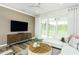 Comfortable living room with sliding glass doors to patio, stylish furnishings, and plenty of natural light at 1622 Garden Park Cir, Fuquay Varina, NC 27526