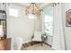 Bright home office featuring a striking chandelier, natural light, and neutral color palette at 1622 Garden Park Cir, Fuquay Varina, NC 27526