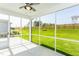 Screened porch overlooking a lush, well-maintained backyard with a beautiful lawn at 1622 Garden Park Cir, Fuquay Varina, NC 27526