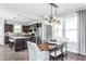 This open concept living space boasts a modern dining area next to the kitchen for easy entertaining at 1626 Garden Park Cir, Fuquay Varina, NC 27526