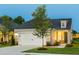 Charming home with a two-car garage, gray siding and professionally landscaped yard provides excellent curb appeal at 1626 Garden Park Cir, Fuquay Varina, NC 27526