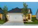 Inviting home exterior featuring a two-car garage, manicured lawn, and a welcoming front entrance at 1626 Garden Park Cir, Fuquay Varina, NC 27526
