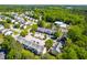 Aerial view of a neighborhood with mature trees, townhomes, and parking areas at 1628 Briarmont Court Ct, Raleigh, NC 27610