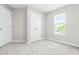 Bedroom with neutral walls, carpet flooring, a window providing natural light, and a closet at 1628 Briarmont Court Ct, Raleigh, NC 27610