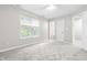 Cozy bedroom with neutral walls, plush carpeting, and a bright overhead fan and fixture at 1628 Briarmont Court Ct, Raleigh, NC 27610