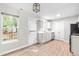 Open eat-in kitchen showcasing laminate floors, bright windows, and stainless appliances at 1628 Briarmont Court Ct, Raleigh, NC 27610