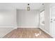 Living space featuring durable floors, neutral walls, and a bright overhead fixture at 1628 Briarmont Court Ct, Raleigh, NC 27610