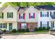 Exterior view of charming townhomes with colorful shutters and landscaped front yards at 1628 Briarmont Court Ct, Raleigh, NC 27610