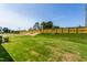 Expansive backyard featuring green grass and a privacy fence surrounding the property at 1630 Garden Park Cir, Fuquay Varina, NC 27526