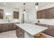 Kitchen with marble backsplash, island with seating, and ample cabinets and countertops at 1630 Garden Park Cir, Fuquay Varina, NC 27526