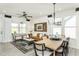 Open-concept living area with lots of natural light and adjoined to the dining area, ideal for gatherings at 1630 Garden Park Cir, Fuquay Varina, NC 27526