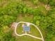 Beautiful aerial view shows a house surrounded by lush landscape and a winding driveway at 169 Country Brooke Lane Ln, Roxboro, NC 27574