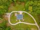 Aerial view features a house with a long winding driveway, surrounded by grass and trees at 169 Country Brooke Lane Ln, Roxboro, NC 27574