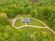 Stunning aerial view of lush greenery surrounding beautiful home at 169 Country Brooke Lane Ln, Roxboro, NC 27574