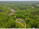 This aerial view features a home surrounded by lush greenery at 169 Country Brooke Lane Ln, Roxboro, NC 27574
