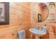 Charming half bathroom with wood-paneled walls and a pedestal sink at 169 Country Brooke Lane Ln, Roxboro, NC 27574