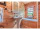 Bright bathroom featuring natural light, pedestal sink, built-in seating, and wooden walls at 169 Country Brooke Lane Ln, Roxboro, NC 27574
