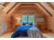 A cozy bedroom showcasing wood-paneled walls and ceiling with built-in storage and natural light at 169 Country Brooke Lane Ln, Roxboro, NC 27574