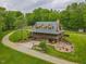 Secluded multi-story home with wrap-around porch and stone chimney nestled on large landscaped lot at 169 Country Brooke Lane Ln, Roxboro, NC 27574