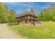 Charming exterior with stone facade, large covered porch, and beautiful landscaping at 169 Country Brooke Lane Ln, Roxboro, NC 27574