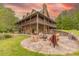 Charming stone home featuring a spacious patio with an outdoor fireplace and ample seating at 169 Country Brooke Lane Ln, Roxboro, NC 27574