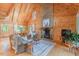 Inviting living room featuring wood paneling, stone fireplace, and comfortable seating area at 169 Country Brooke Lane Ln, Roxboro, NC 27574