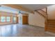 Spacious living room with tile floors, natural light, and staircase leading to a second story at 169 Country Brooke Lane Ln, Roxboro, NC 27574