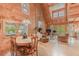 Cozy and open living space featuring wood paneling, fireplace, large windows, and a dining area with hardwood floors at 169 Country Brooke Lane Ln, Roxboro, NC 27574