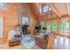 Spacious living room featuring wood accents, comfortable seating, and a stone fireplace at 169 Country Brooke Lane Ln, Roxboro, NC 27574