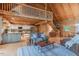 Open-concept living room with hardwood floors, a stone fireplace, and an adjacent modern kitchen at 169 Country Brooke Lane Ln, Roxboro, NC 27574