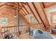 Cozy loft area featuring wood-paneled walls, vaulted ceilings, and a stone accent wall at 169 Country Brooke Lane Ln, Roxboro, NC 27574